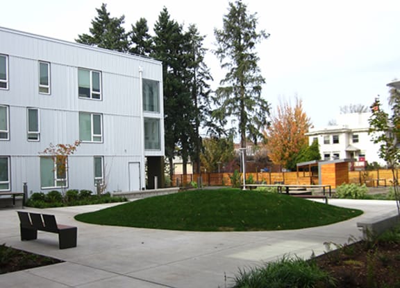 a courtyard in front of a white building