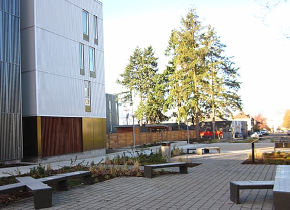 a courtyard with benches in front of a building