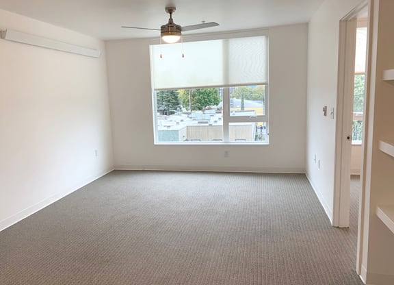 an empty living room with a large window