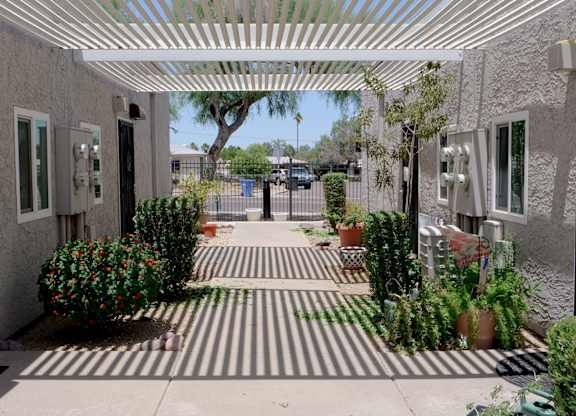A striped walkway leads to a building entrance.