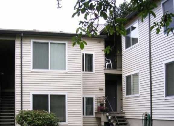A two-story apartment building with a bicycle parked in front.