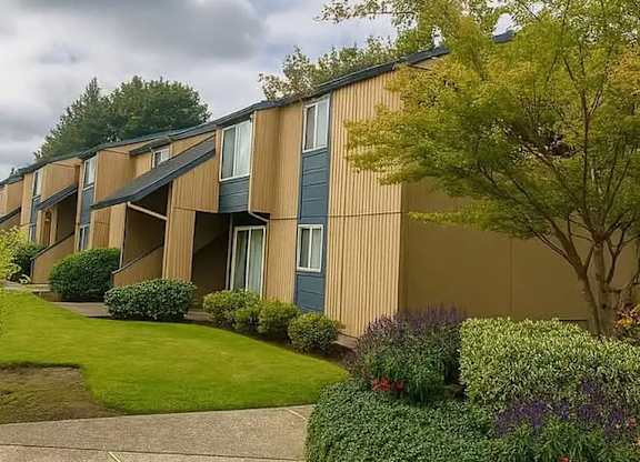 Apartment building with a green lawn in front.
