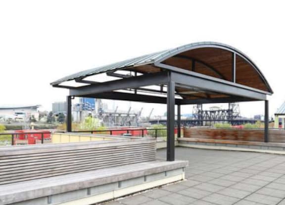 A shelter with a curved roof is made of wood and metal.