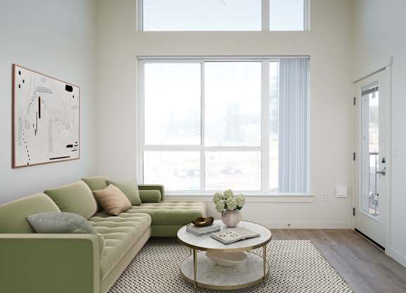 A living room with a green couch and a coffee table.