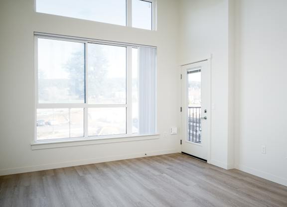 A room with a large window and a door.