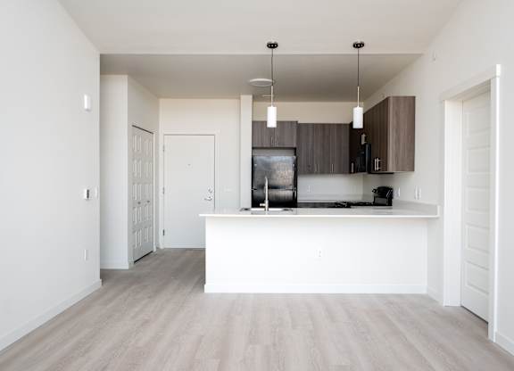 A kitchen with a white counter and cabinets.