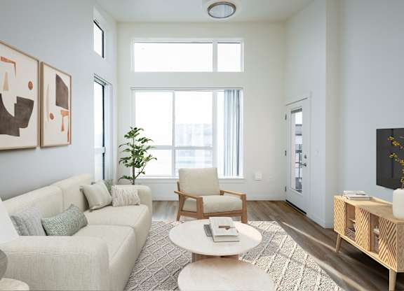 A living room with a couch, chair, and a table.