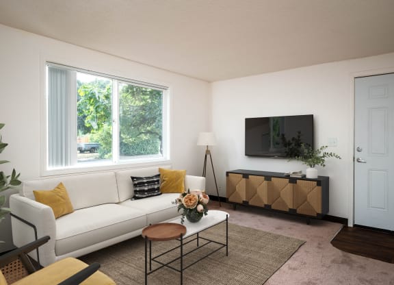 a living room with a white couch and a television