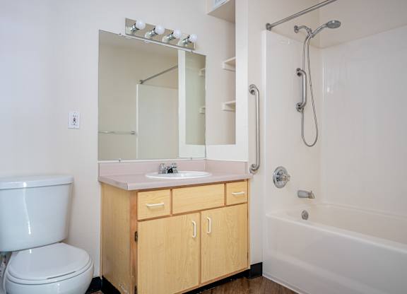 A white bathroom with a sink, toilet, and bathtub.