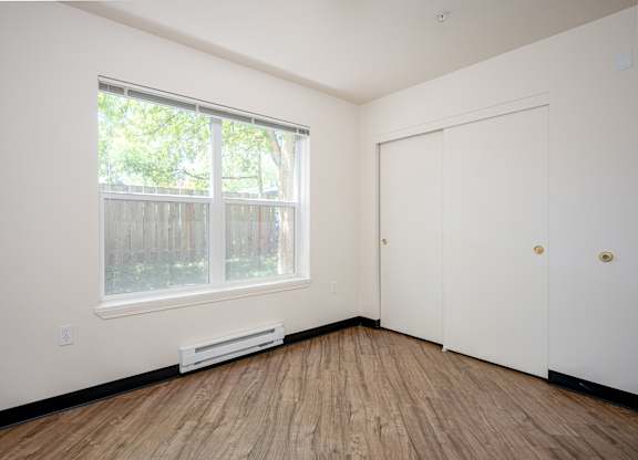 A room with a window and a door.