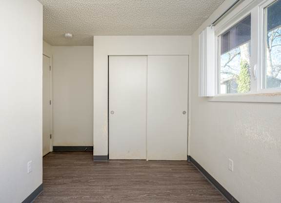 A room with a white door and a window.