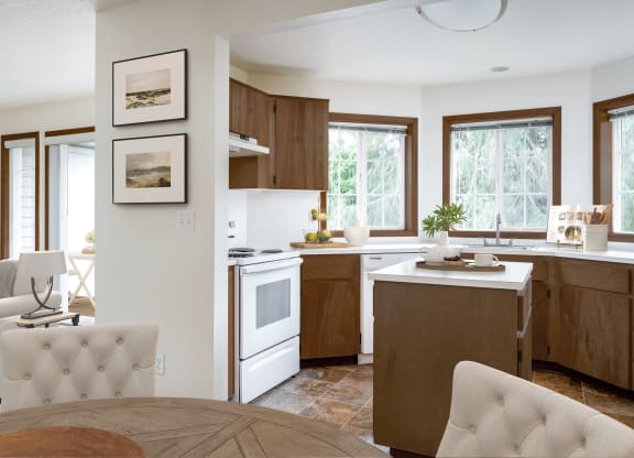 a kitchen with white appliances and wooden cabinets