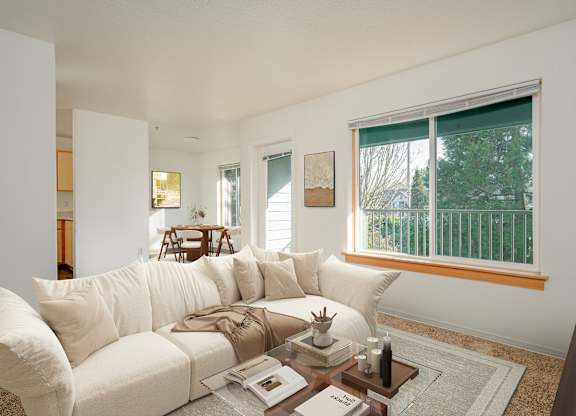 A white couch with a coffee table in front of it.