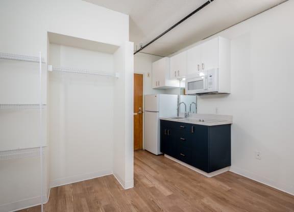 a kitchen with white cabinets and a dark blue island