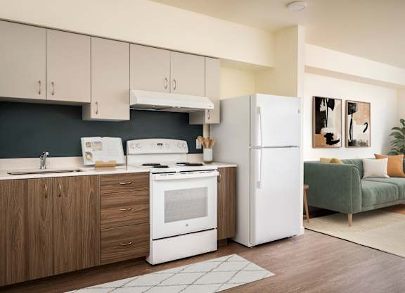 A modern kitchen with white appliances and wooden cabinets.