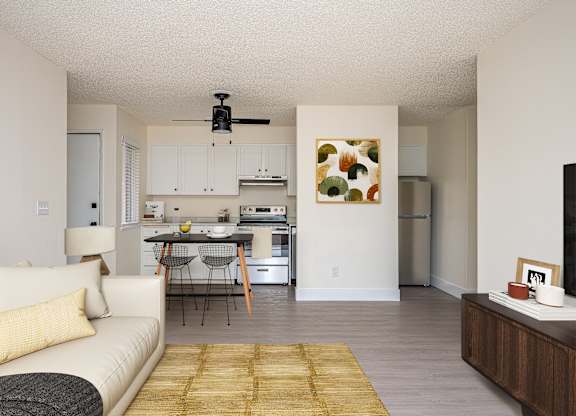 A living room with a couch, a dining table, and a kitchen in the background.