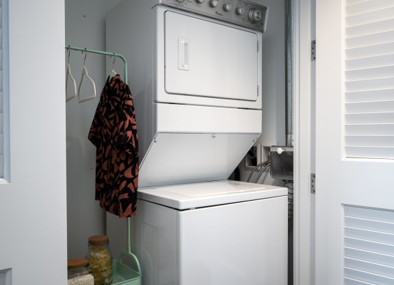 a white washer and dryer in a small laundry room