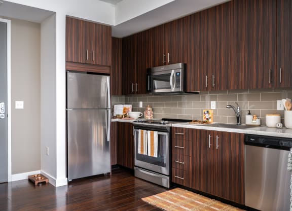 a kitchen with stainless steel appliances and wooden cabinets