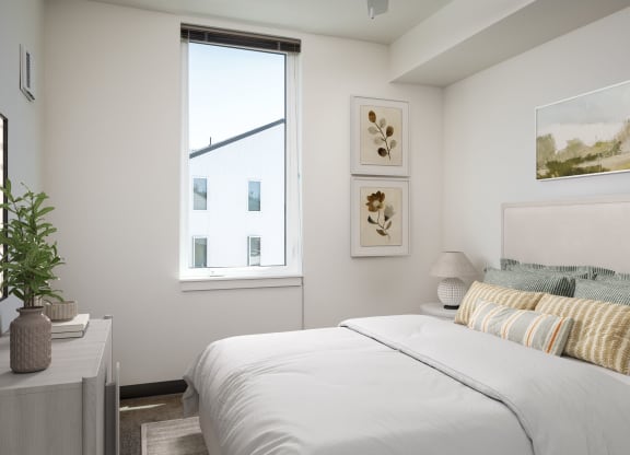 a bedroom with a large bed and a window