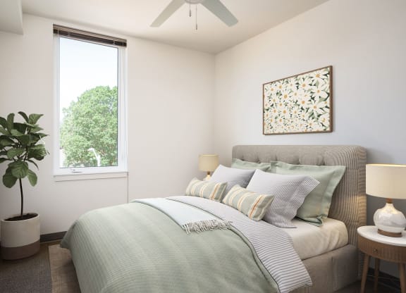 a bedroom with a bed and a ceiling fan