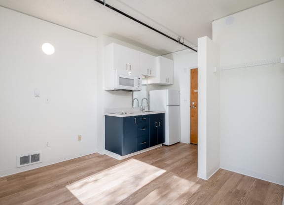 a kitchen with white cabinets and a blue kitchen island