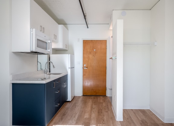 a kitchen with white cabinets and a blue counter top
