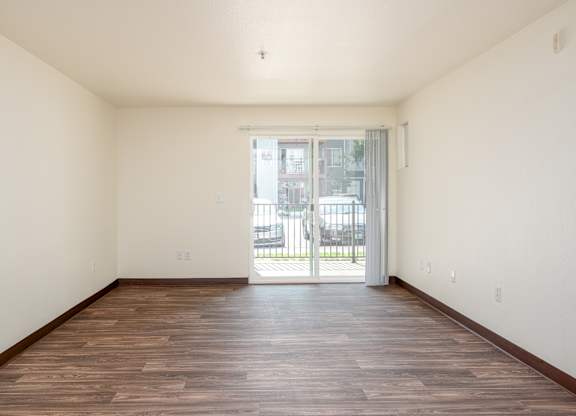 A room with wooden floors and white walls.