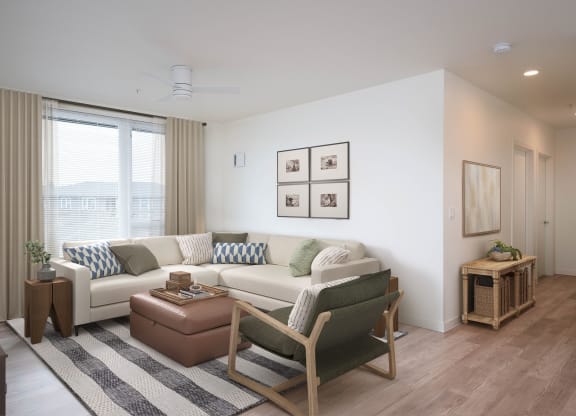 a living room with white walls and wooden floors