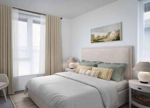 a bedroom with a bed and two windows in a 555 waverly unit