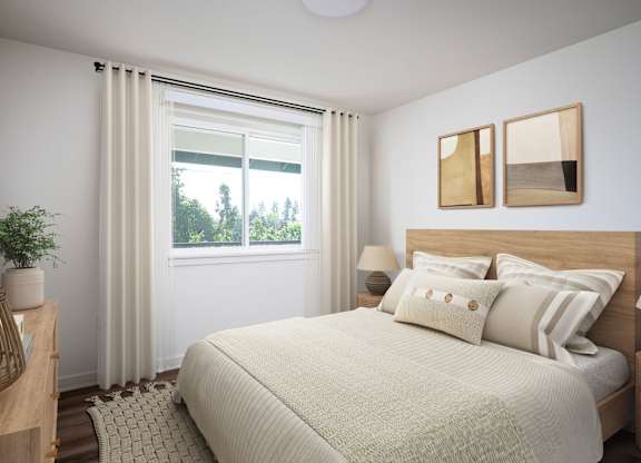 A bedroom with a large bed and a window with curtains.