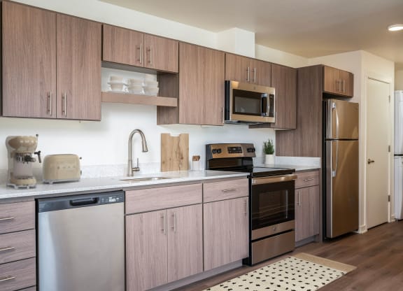a kitchen with stainless steel appliances and wooden cabinets