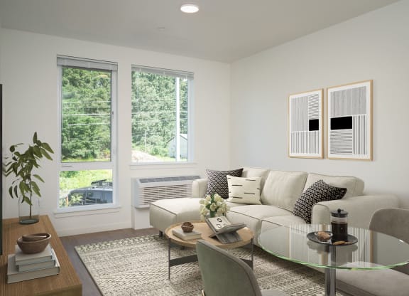 a living room with a couch and a table and three windows