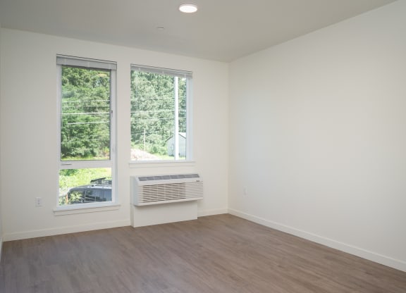 an empty room with white walls and a window