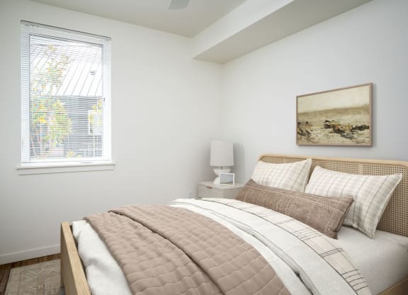 a bedroom with a bed and a window