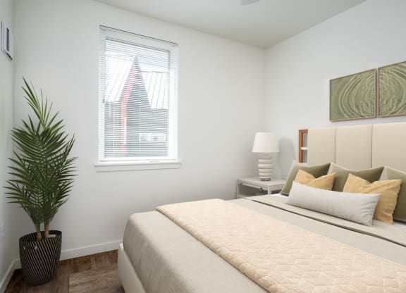 a bedroom with a large bed and a window