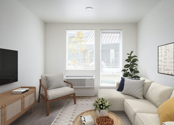 a living room with a couch and a chair and a television