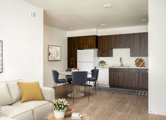 a living room and kitchen with a table and chairs and a couch