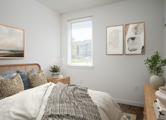 a bedroom with a bed and pictures on the wall