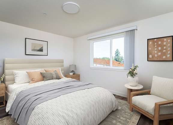 A bedroom with a large bed and a chair.