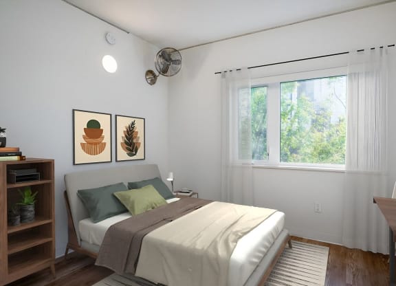 a bedroom with white walls and a bed with green pillows