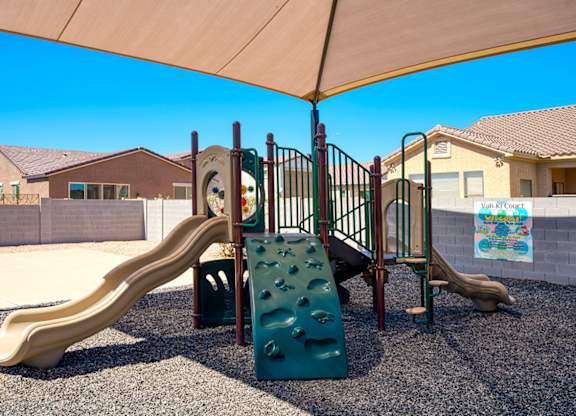 A playground with a slide and a climbing structure.
