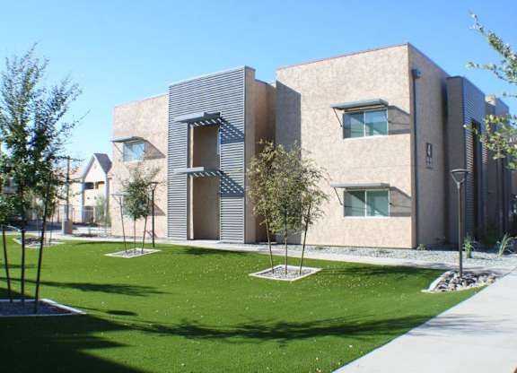 A modern building with a green lawn in front.