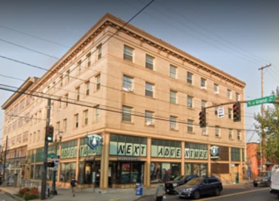 A street view of a building with the words "NEXT" and "LAUGH" on the front.