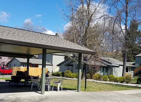 a patio with a table and chairs in front of houses