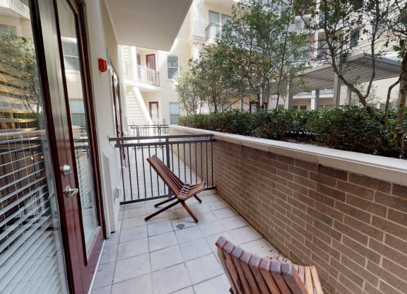 Patio area facing natural landscaping and courtyard area