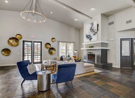 A living room with a fireplace and a blue chair.