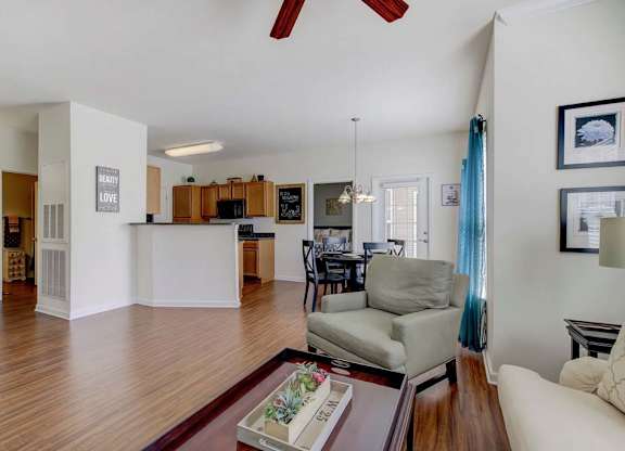 A living room with a grey couch and a coffee table. at Ethan Pointe Apartments, North Carolina, 27215