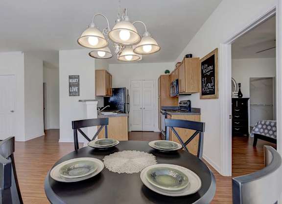 A modern dining room with a black table and chairs at Ethan Pointe Apartments, North Carolina, 27215