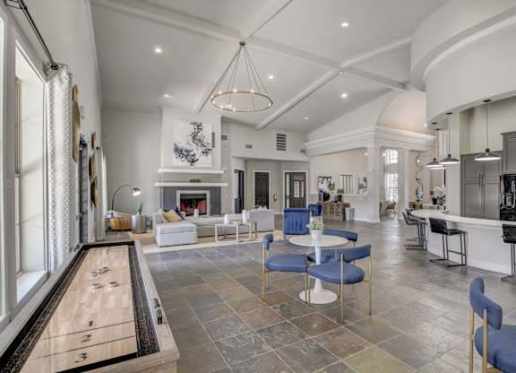 A billiard table is in the middle of a spacious room with a pool table.