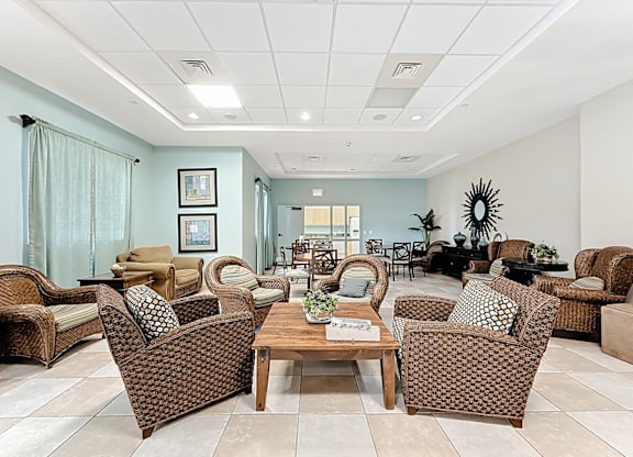 A clubhouse lounge area with chairs and a table